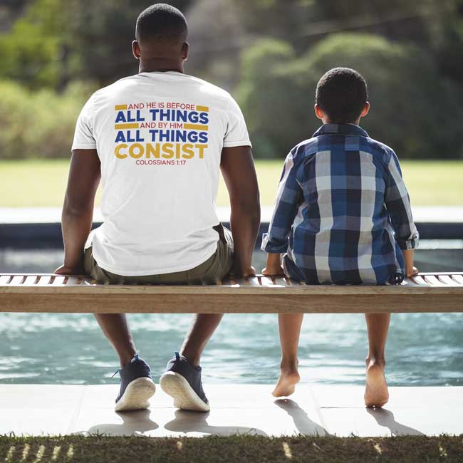 JATC Collection blue desing on white shirt worn by a man next to a child